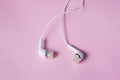 White headphones on a pink background. Royalty Free Stock Photo