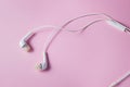 White headphones on a pink background. Royalty Free Stock Photo