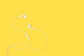 White headphones on a yellow background