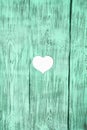 White heart carved in a green wooden board. Background. Royalty Free Stock Photo