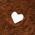 White heart in the middle of the brown soft coffee earthy background.Valentine spring concept design.Love idea