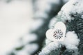 White heart with ornament on spruce branch covered with snow. Royalty Free Stock Photo