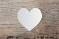 White heart paper on old wooden for valentine`s day message