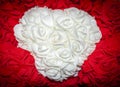 White Heart of Roses in the Embrace of Red Flowers. Symbol of Eternal Love. Floral Background. Romantic Mood Royalty Free Stock Photo