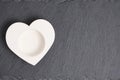 White heart shaped candlestick on slate stone background Royalty Free Stock Photo