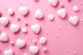 White heart-shaped decorations and beads on a barbie pink background for valentines day celebration