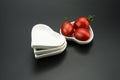 White heart-shaped dish, and small red tomatoes Royalty Free Stock Photo
