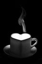 A white heart-shaped mug with a warm drink and a fancy curly steam rising up. A steaming coffee cup Royalty Free Stock Photo