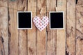 White heart and two photo frame hanging on clothesline rope with Royalty Free Stock Photo