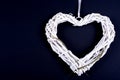 White heart from wickerwork with grass on black background Royalty Free Stock Photo