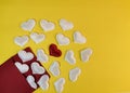 White hearts fly out of a red envelope and in the center is one red heart on a yellow background Royalty Free Stock Photo