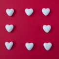 White hearts on a red background form a square with copy space. Minimal love scene