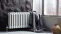 Modern central heating battery close-up. Warm gray plaid hanging on the radiator Royalty Free Stock Photo