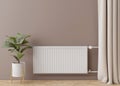 White heating radiator with thermostat on brown wall. Central heating system. Free, copy space for your text. 3D