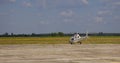 A white helicopter stands at the airport near the yellow field. Blue sky, beautiful landscape. Place for text. Copy space Royalty Free Stock Photo