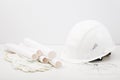 White helmet, gloves, plan, drawings, construction glasses on white background, construction concept Royalty Free Stock Photo