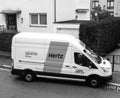 White HERTZ rent a van service seen from above on a French stree