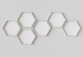 White hexagon blank photo frames mockup hanging on interior wall. Hexagonal pictures on painted surface. 3D rendering Royalty Free Stock Photo