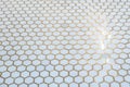 a white hexagon ceramic marble style tile floor with gold inlay grout Royalty Free Stock Photo