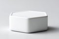 White hexagonal ceramic container placed on a light background showcasing minimalist design and smooth surface Royalty Free Stock Photo