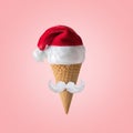 White hipster mustache and hat of Santa Claus with ice cream cone on pink background. New Year or Christmas minimal concept Royalty Free Stock Photo