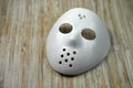 White hockey ice mask on wooden table background