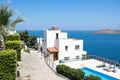 White holiday villas houses on resort with sea view and swimming pool and palm trees Royalty Free Stock Photo