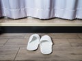 White home fabric disposable slippers on wooden floor tile Royalty Free Stock Photo