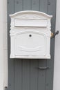 White home mailbox with grey wood background