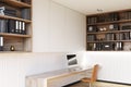 White home office corner with a wooden floor.