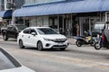 White Honda City on the road in the city with traffic