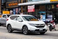 White Honda CR-V on the road in the city with traffic