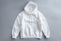 White Hooded Sweatshirt Displayed Against Gray Background