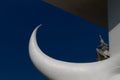 White horn, elephant tusk, white crescent with deep blue sky and temple in the background