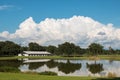 White horse barn on farm with lake and blue sky Royalty Free Stock Photo