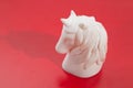 White horse toy isolated on the red background Royalty Free Stock Photo