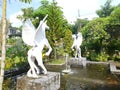 A white horse statue in a fish pond as a hotel icon at the foot of Mount Kediri Royalty Free Stock Photo