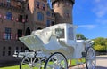 White carriage in front of a beautiful castle.