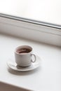 White hot coffe cup on windowsill Royalty Free Stock Photo