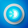 White Hot and cold symbol. Sun and snowflake icon isolated on blue background. Winter and summer symbol. Circle blue