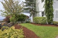 White houe and newly landscaped yard with fence.