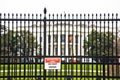 White House back garden iron fence and security warning view