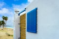 White house on the beach with blue shutters Royalty Free Stock Photo