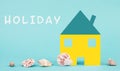 White house on a blue colored background with sea shells, booking an appartment, hotel or lounge for vacation, holidays in summer