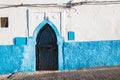 White house with blue detail and a gate, Morocco