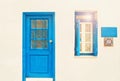 White house with blue door and open window on sunny day Royalty Free Stock Photo