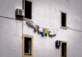 White House Facade with Laundry. Colorfull Clothes on the Rope Drying on the Wall of a Building in Croatia