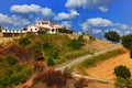 White house on hill with trees and bushes Royalty Free Stock Photo