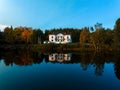 white house on the lake in a forested area, surrounded by trees Royalty Free Stock Photo