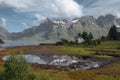 White house and mirror lake with view to snow mountains and sea in the Norway at summer Royalty Free Stock Photo